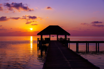Fototapeta na wymiar Water cafe at sunset - Maldives