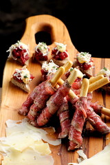 Grissini bread sticks with ham, Cheese,on old wooden background