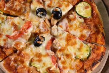 close up of pizza on wooden board.