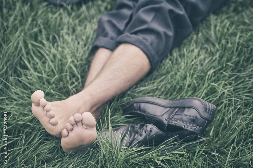 Wall mural man lying on the grass