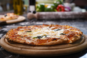 close up of pizza on wooden board.