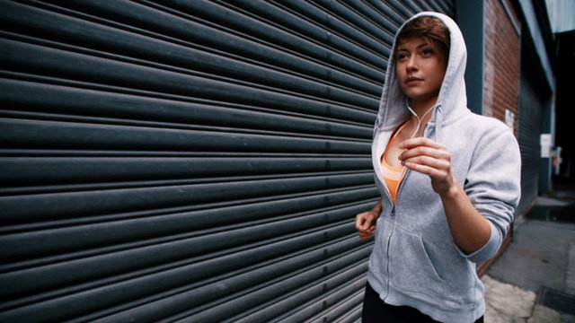 Slow Motion video of young fit woman running in cold weather
