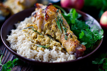 Baked chicken leg with rice garnish