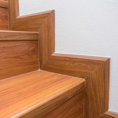 wooden staircase made from laminate wood in white modern house