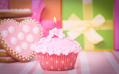 birthday cupcake with candle and presents