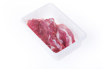 raw pork in plastic box package isolated on white background