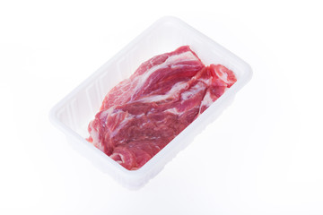 raw pork in plastic box package isolated on white background