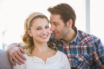 Loving couple sitting on couch