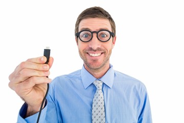 Geeky businessman holding a cable