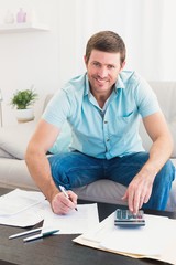 Smiling man counting his bills