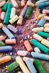 Collection of rainbow colored pastel crayons with pigment dust o