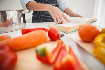Woman following a recipe in book