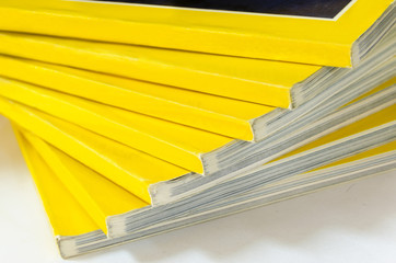 Closeup background of a pile of old magazines