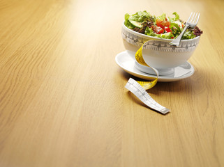 Dieting with a Bowl of Salad and Tape Measure