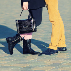 Male and female legs during a date. 