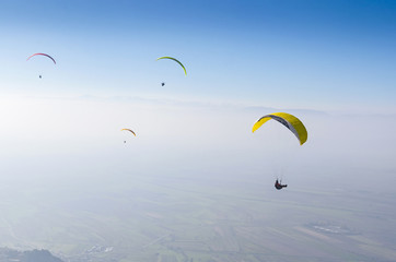 Paragliders flying high above mountains 