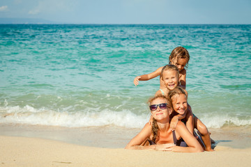 Happy family lying on the beach at the day time