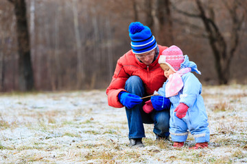 father and little daughter playing in winter