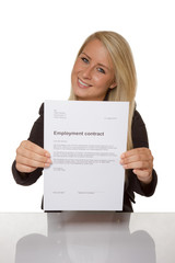 Happy young woman is happy about her employment contract - 74136945