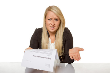 Young woman got a job application rejection a looks astonished - 74136987