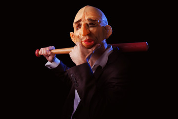 Scary man in suit with mask and baseball bat