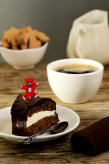 Carrot cake with coffee and teddy bear stick