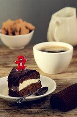 Carrot cake with coffee and teddy bear stick