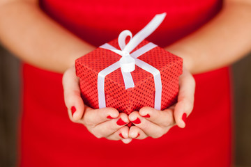 Female hands holding a present box