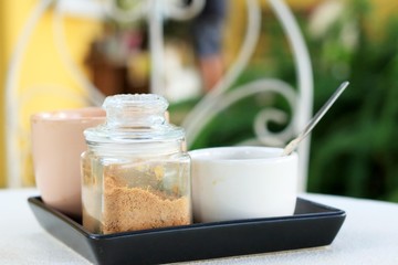 Cup of coffee and sugar on the table.