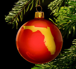 Red bauble with the golden shape of Florida