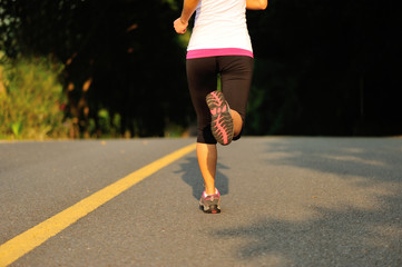 Fototapeta premium fitness woman running at forest road