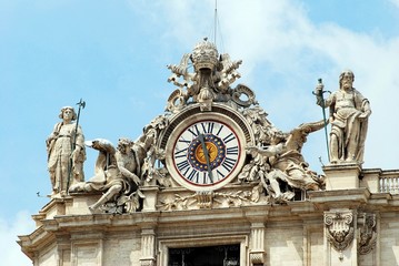 Sculptures and clock on the facade of Vatican city works