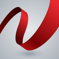 Red fabric curved ribbon on grey background