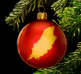 Red bauble with the golden shape of Isle of Man