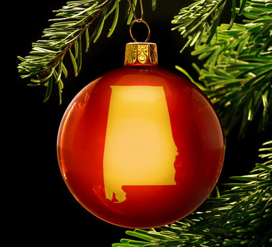 Red bauble with the golden shape of Alabama hanging on a christm