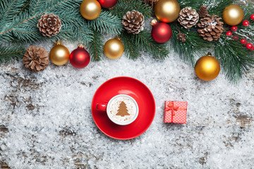 Cappuccino with christmas tree shape and gift box on artificial