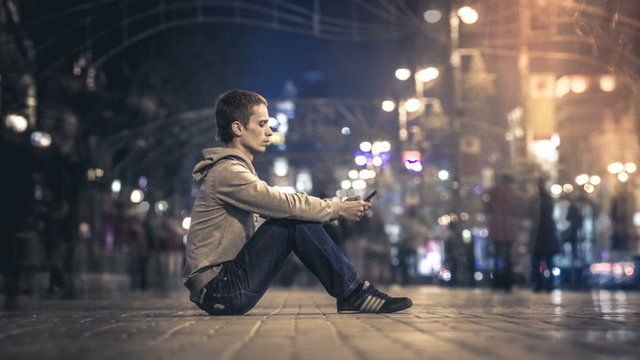 Man sitting by the crowd stream. Time lapse