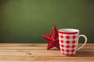 Cup of tea on wooden table with Christmas decoration
