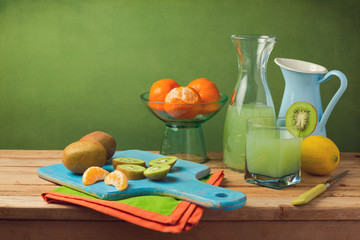 Healthy fruits and juice on wooden table