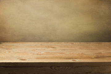 Wooden table over grunge wallpaper