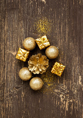 Fototapeta na wymiar Golden Vintage Balls and Gifts with Glitter on Wooden Background