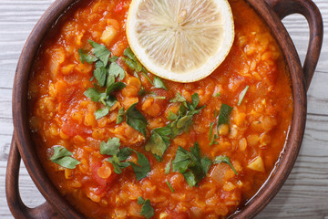 soup with red lentils and tomatoes macro horizontal. top view