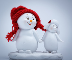 Cheerful snowman and penguin