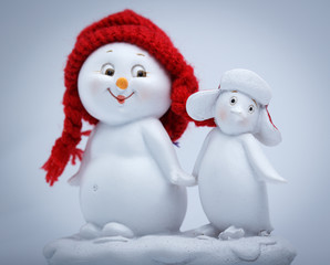 Cheerful snowman and penguin