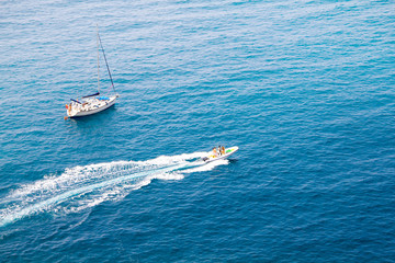 Obraz premium A Boat and a Yacht in the Mediterranean sea, Italy