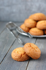 Heap of almond cookies on rustic wooden background