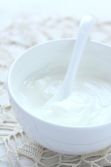 Fresh cream cheese spread in white bowl with spoon