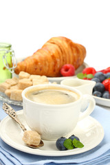 Breakfast with cup of coffee, croissants and berries