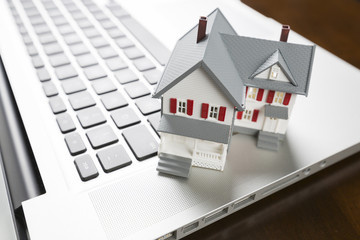 Miniature House on Laptop Computer