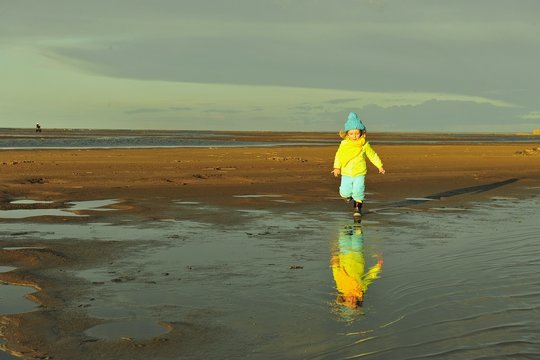 Little girl  on a sandy coast